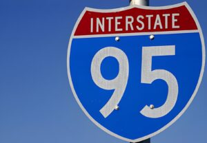 Aerial view of Interstate 95 highway with multiple lanes of traffic flowing through an urban area